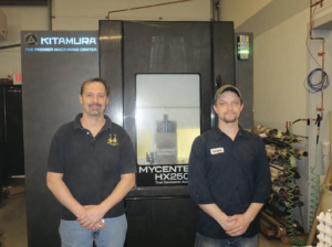 (l-r) Dan Labonville, President and Dwayne Dunton, Crucial Component Machining LLC, Concord, NH, with the Kitamura Mycenter-HX250G horizontal machining center that has a super compact, small footprint.